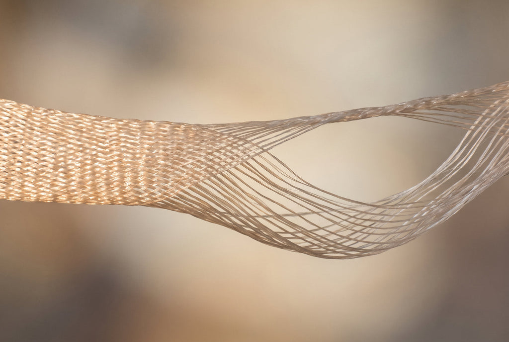 An illustration of the fascial sling that suspends the female pelvic organs, with its weave visibly loosening at one end.